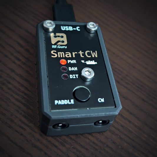 SmartCW square close-up showing its USB-C connection, PWR, DAH and DIT LEDs, PTT button, and PADDLE and CW jacks